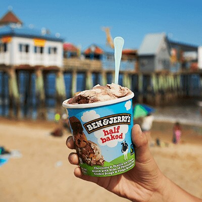 Pint of Half Baked in front of a pier