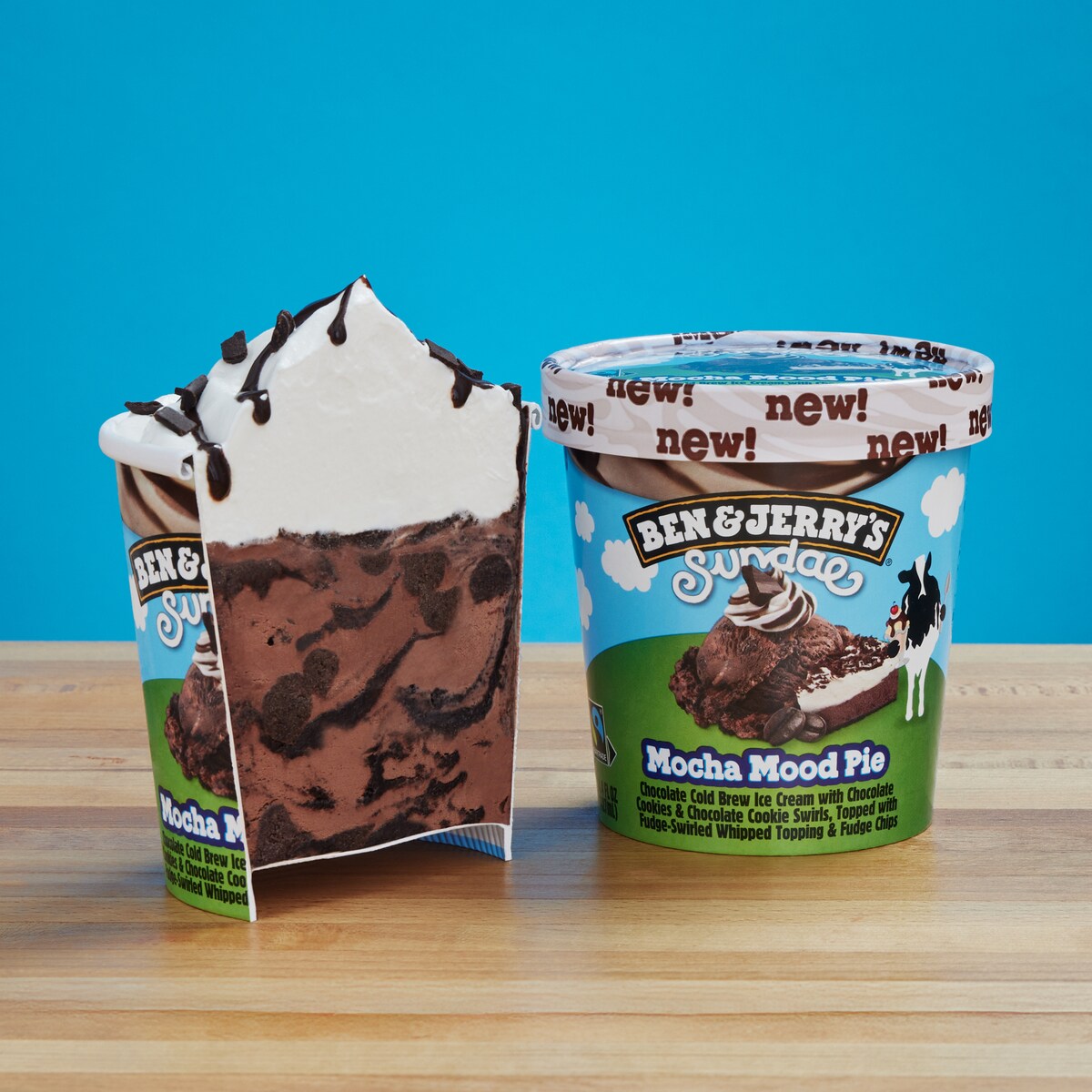 Ben & Jerry's Mocha Mood Pie Sundae ice cream with the pint cut in half so you can see the layers of ice cream and whipped topping.