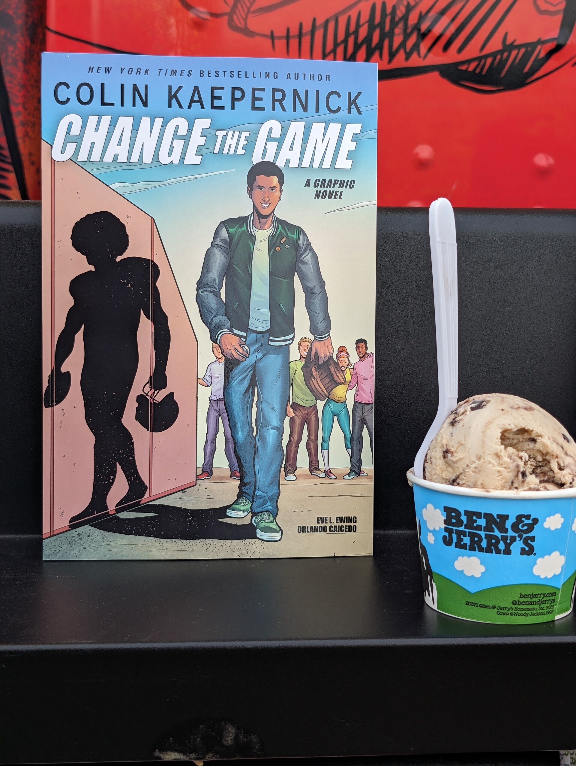 Photo of a banned book with a scoop of Ben & Jerry's ice cream next to it.