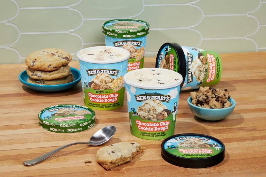 Pints of Ben & Jerry's Chocolate Chip Cookie Dough ice cream open on a wood table.