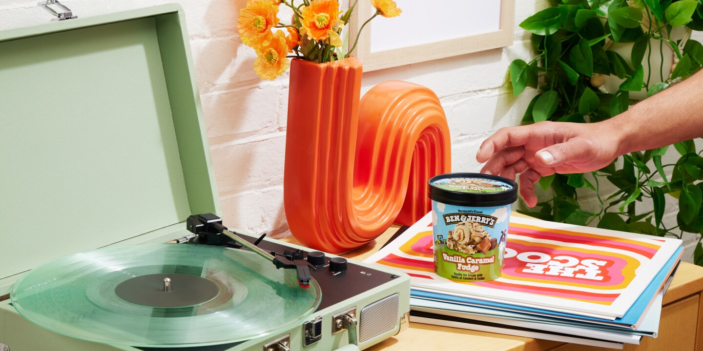Pint of Ben & Jerry's ice cream in a dorm room setting next to a record player.