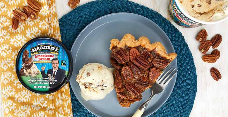 Photo of a pint of Ben & Jerry's Americone Dream ice cream next to a slice of pecan pie. Thanksgiving set styling.