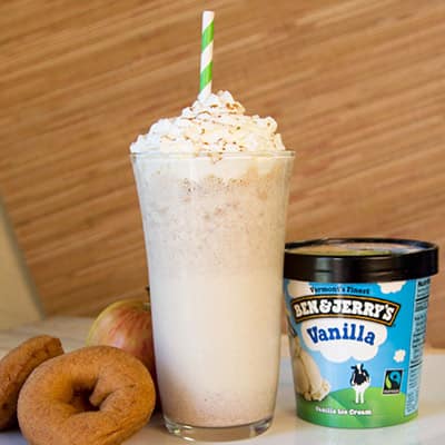 Ben & Jerry's Vanilla ice cream next to a maple cider donut milkshake and a cider donut.