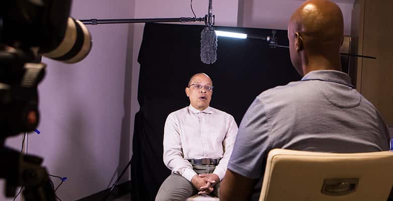 Photo of Jeffery Robinson being interviewed by a Ben & Jerry's team member.